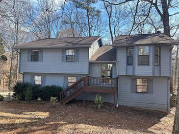 Two-story house with gray siding, wood deck, and mature trees at 4551 Jackybell Trl, Decatur, GA 30034