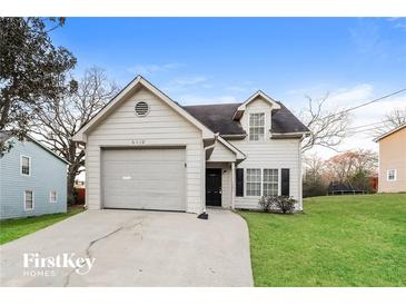 Charming one-story house with a gray garage and a well-maintained lawn at 6110 Dorsett St, Douglasville, GA 30134