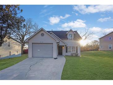 Cute two-story house with a gray garage door and a well-maintained lawn at 6110 Dorsett St, Douglasville, GA 30134