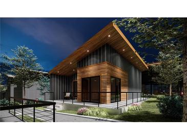 Modern home exterior with wood and metal siding, spacious deck, and landscaped yard at 6305 Shannon Pkwy # 201, Union City, GA 30291