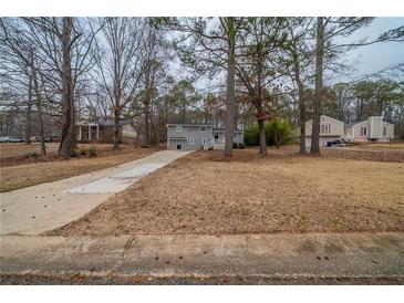 Traditional two-story home featuring a long drive and mature trees in a suburban neighborhood at 6520 Chickasaw Dr, Douglasville, GA 30135