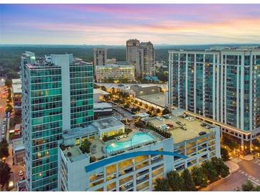 Aerial view of a modern city building complex with a rooftop pool at dusk at 250 Pharr Ne Rd # 413, Atlanta, GA 30305