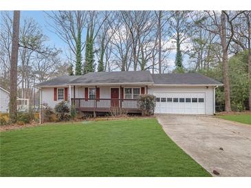 Ranch home with a carport and a grassy lawn at 4179 White Rd, Snellville, GA 30039