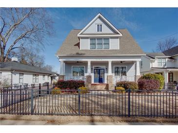 Two-story craftsman home with gray siding, brick accents, and a charming front porch at 1559 Walker Ave, College Park, GA 30337