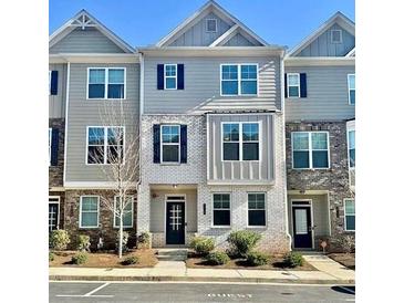 Attractive townhome with a blend of grey siding and white brick, enhancing curb appeal and architectural detail at 1716 Prelude, Marietta, GA 30067