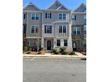 Two-story townhome with neutral siding and landscaping at 1716 Prelude, Marietta, GA 30067