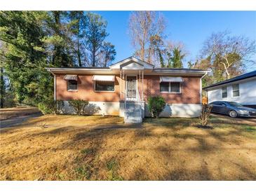 Brick ranch home with a landscaped yard and attached carport at 2257 Polar Rock Sw Ave, Atlanta, GA 30315