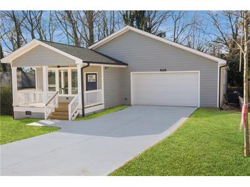 Gray house with white garage door, front porch, and landscaped lawn at 2195 Springdale Sw Rd, Atlanta, GA 30315