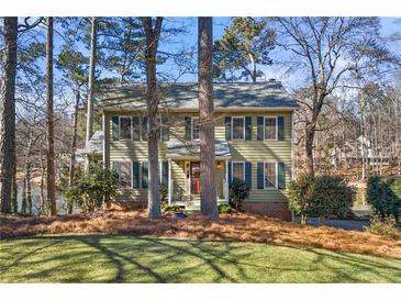 Two-story house with green siding, shutters, and a large yard at 1925 Annwicks Dr, Marietta, GA 30062