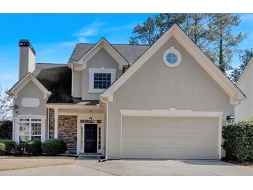 Two-story house with gray siding, stone accents, and a two-car garage at 2124 Berryhill Se Cir, Smyrna, GA 30082