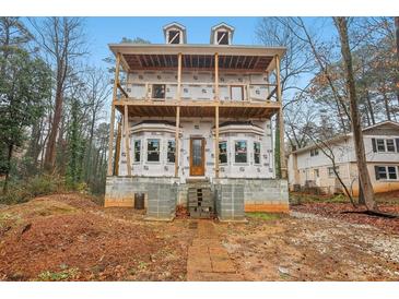 Two-story home with unfinished construction, large windows, and a spacious unfinished second-story balcony at 3160 Hathaway Ct, Atlanta, GA 30341