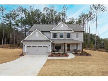 Two-story house with gray siding, shutters, and a three-car garage at 1121 Red Oak Ln, Loganville, GA 30052