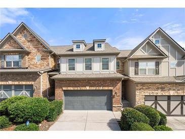 Brick front townhouse with gray garage door and landscaping at 5649 Cobblestone Creek Pl # 13, Mableton, GA 30126