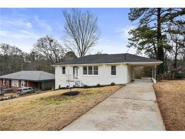 Charming painted brick home with a covered carport and well-maintained front lawn at 2724 Larkspur Se Dr, Atlanta, GA 30316