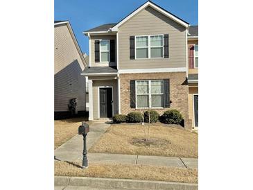 Two-story townhome with neutral siding, black shutters, and a small front yard at 2169 Olmadison Vw, Atlanta, GA 30349