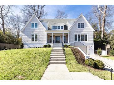 Beautiful two-story home with gray siding, manicured lawn, and a welcoming front porch at 2624 Forrest Ne Way, Atlanta, GA 30305