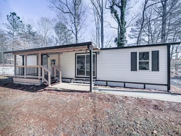 Updated mobile home with covered porch and landscaped yard at 337 Theodore Cox Cir, Canton, GA 30114