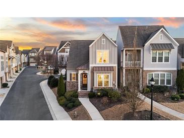 Attractive 2 story townhome with charming front porch and landscaping at 332 Symphony Se Way, Smyrna, GA 30080