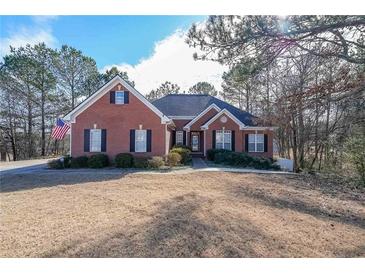 Brick house with a large front yard and mature trees at 1765 Rubye Lee Ln, Dacula, GA 30019