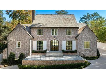 Brick home with a gabled roof, white shutters, and a large front porch at 2515 Habersham Nw Rd, Atlanta, GA 30305