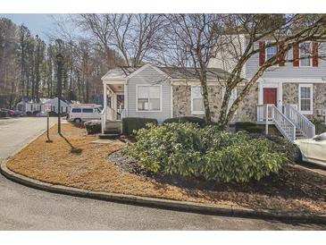 Gray siding townhouse with stone accents, steps, and landscaping at 4018 Bayside Cir, Atlanta, GA 30340