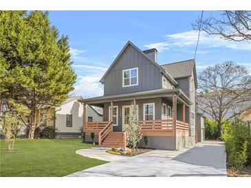 Gray farmhouse exterior with front porch, landscaping, and driveway at 3378 Bachelor St, Atlanta, GA 30344