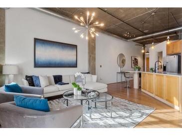 Bright living room featuring stylish decor, hardwood floors, and an open layout for modern living at 3235 Roswell Ne Rd # 615, Atlanta, GA 30305