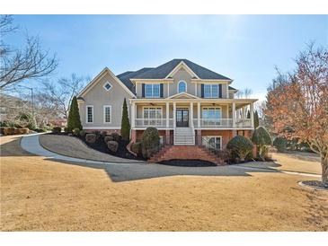 Two-story house with brick accents and a landscaped lawn at 1078 Meadow Brook Dr, Woodstock, GA 30188