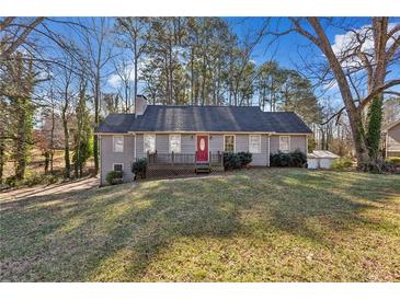 Gray house with red door, deck, and grassy yard at 1058 Hickory Rd, Canton, GA 30115