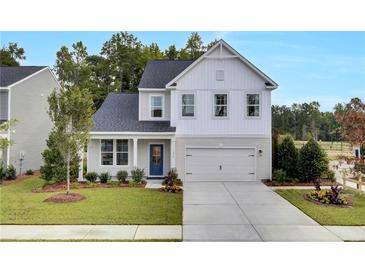 Two-story home with gray siding, blue door, and attached garage at 410 Newland Way, Acworth, GA 30102