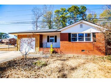 Brick ranch house with a spacious yard and attached garage at 6531 Temple St, Lithia Springs, GA 30122
