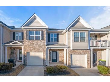 Charming townhome with brick accents, attached garage, and well-maintained landscaping at 7116 Fringe Flower Dr # 19, Austell, GA 30168