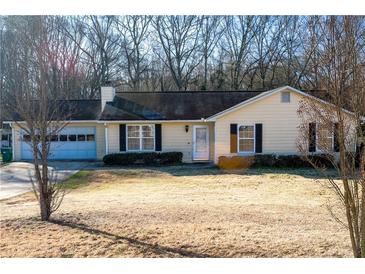 Ranch style home with attached garage and spacious yard at 106 Gwenellen Dr, Locust Grove, GA 30248