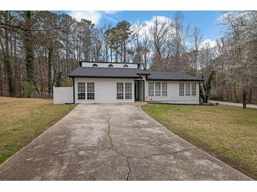 Charming single-story home with a long driveway and manicured lawn at 3178 Berrong Way, Stone Mountain, GA 30087