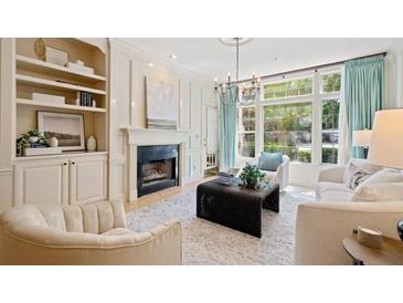 Bright living room with fireplace, built-ins, and large windows at 3636 Habersham Nw Rd # 1108, Atlanta, GA 30305