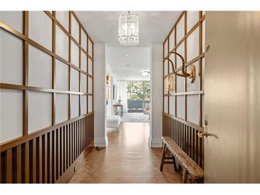 Elegant entryway with wood flooring, built-in shelving, and a bench at 2575 Peachtree Ne Rd # 9G, Atlanta, GA 30305