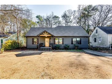 Charming craftsman style home with gray siding, modern door, and landscaped yard at 2508 Connally Dr, East Point, GA 30344