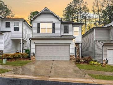 Two story townhome featuring a two car garage and craftsman style architecture at 319 Pinewood Dr, Woodstock, GA 30189