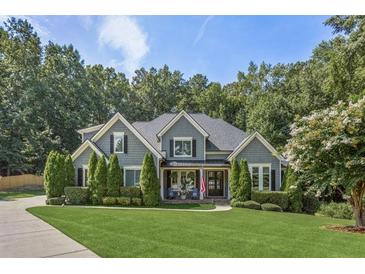 Gray two-story house with large front yard and landscaping at 1185 Weldstone Ct, Atlanta, GA 30350