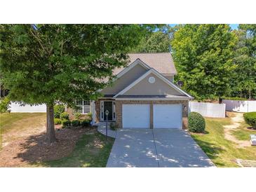 House exterior with two-car garage and landscaped yard at 2401 Centennial Hill Nw Way, Acworth, GA 30102