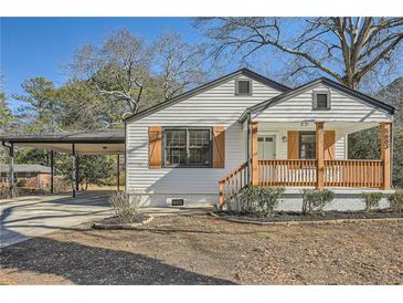 Charming renovated home with white siding, a covered porch, and a landscaped yard at 5603 Owens Dr, Austell, GA 30106