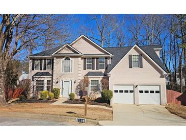 Two-story house with a two-car garage and well-manicured lawn at 6108 Waterton Dr, Lithonia, GA 30058