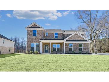 Brick two-story house with front porch and landscaped lawn at 108 Aj Welch Jr Way, Mcdonough, GA 30252