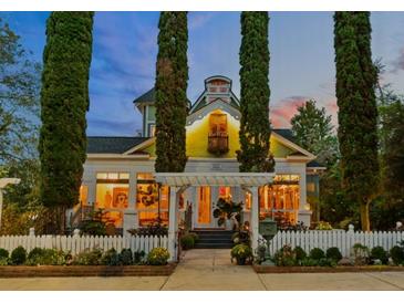 Evening view of charming two-story home with white picket fence at 3532 South Fulton Ave, Hapeville, GA 30354