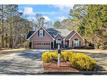 Beautiful ranch home with a large front yard, two-car garage, and mature landscaping at 430 Flowering Trl, Grayson, GA 30017