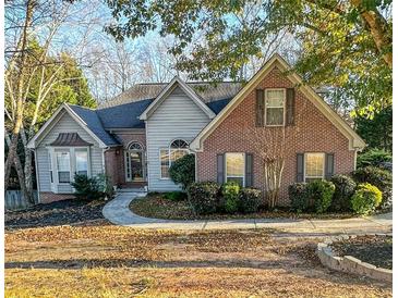 Brick and shingle two-story house with landscaping and walkway at 733 Exchange Mill, Dacula, GA 30019