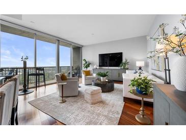Bright living room with hardwood floors, city views, and stylish furnishings at 1080 Peachtree Ne St # 3309, Atlanta, GA 30309