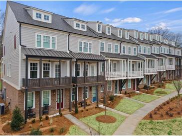 Charming townhomes featuring craftsman-style architecture and landscaped front yards at 1979 Flying Scotsman Dr # 16, Kennesaw, GA 30144