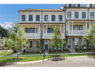 Charming townhome featuring brick accents, white trim, covered porches, and well-maintained landscaping at 1979 Flying Scotsman Dr # 16, Kennesaw, GA 30144