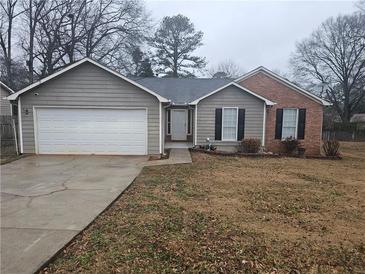 Ranch style home with attached garage and landscaped yard at 3684 Paddington Trl, Rex, GA 30273